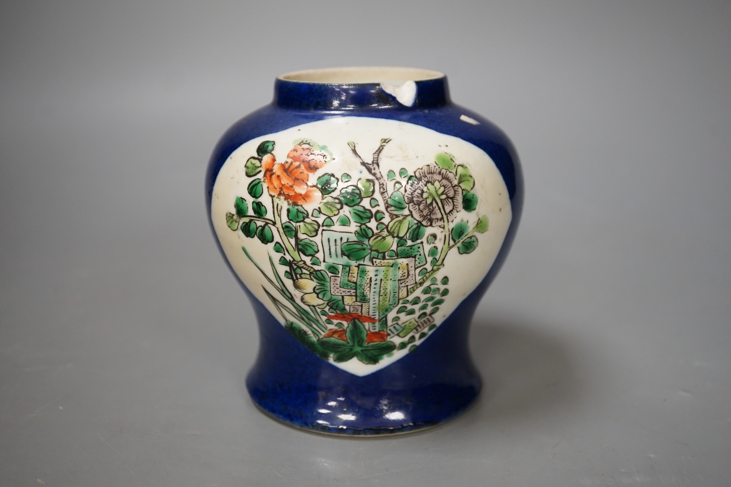 A Chinese powder blue vase, late 19th century, with panelled floral decoration (a.f.). 12cm high